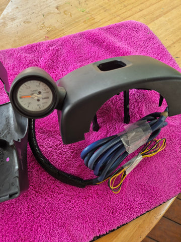 White Faced Lamco Boost Gauge Black face with housing and OEM Steering wheel column cover